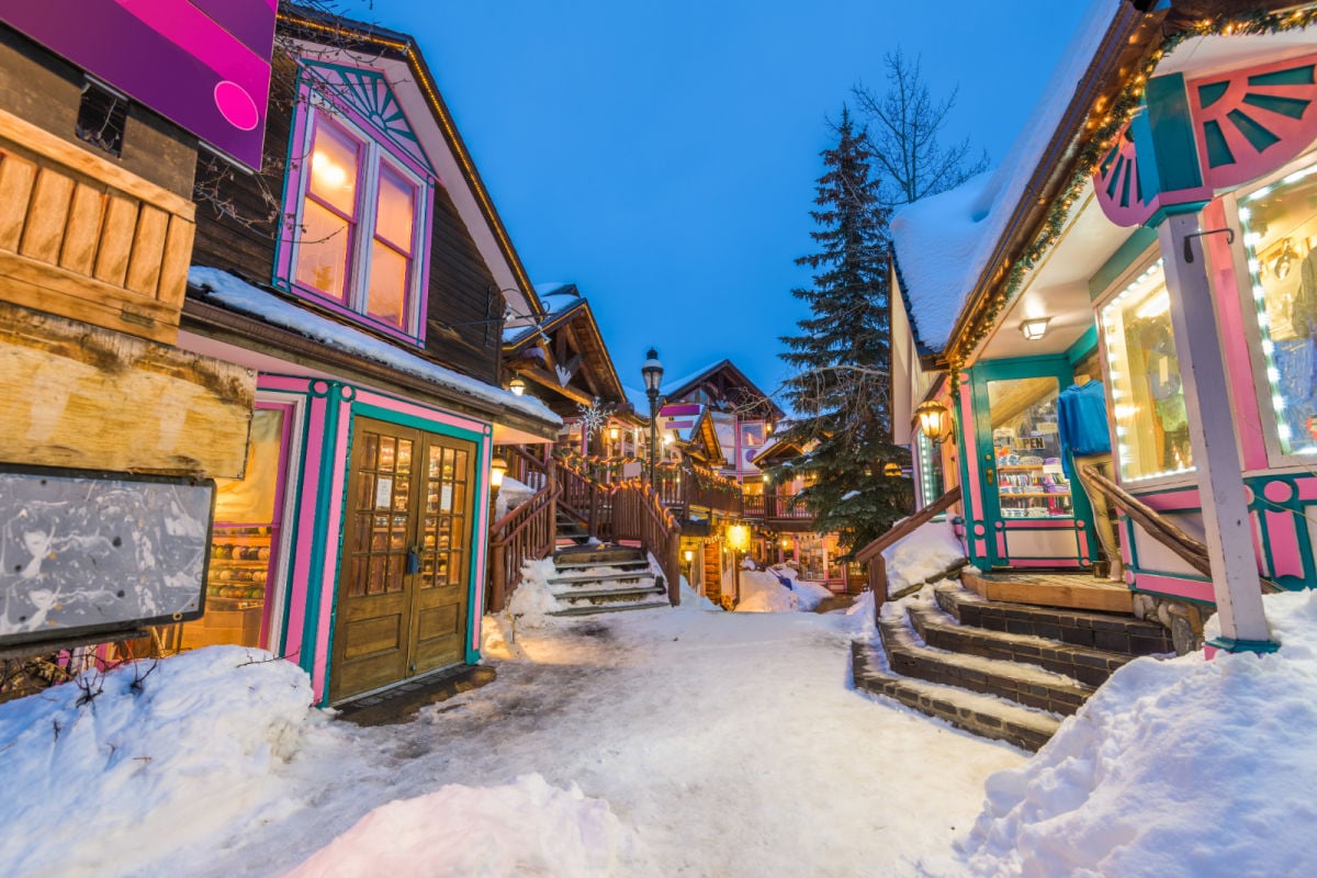 a snowy street in breckenridge colorado with wooden lodges