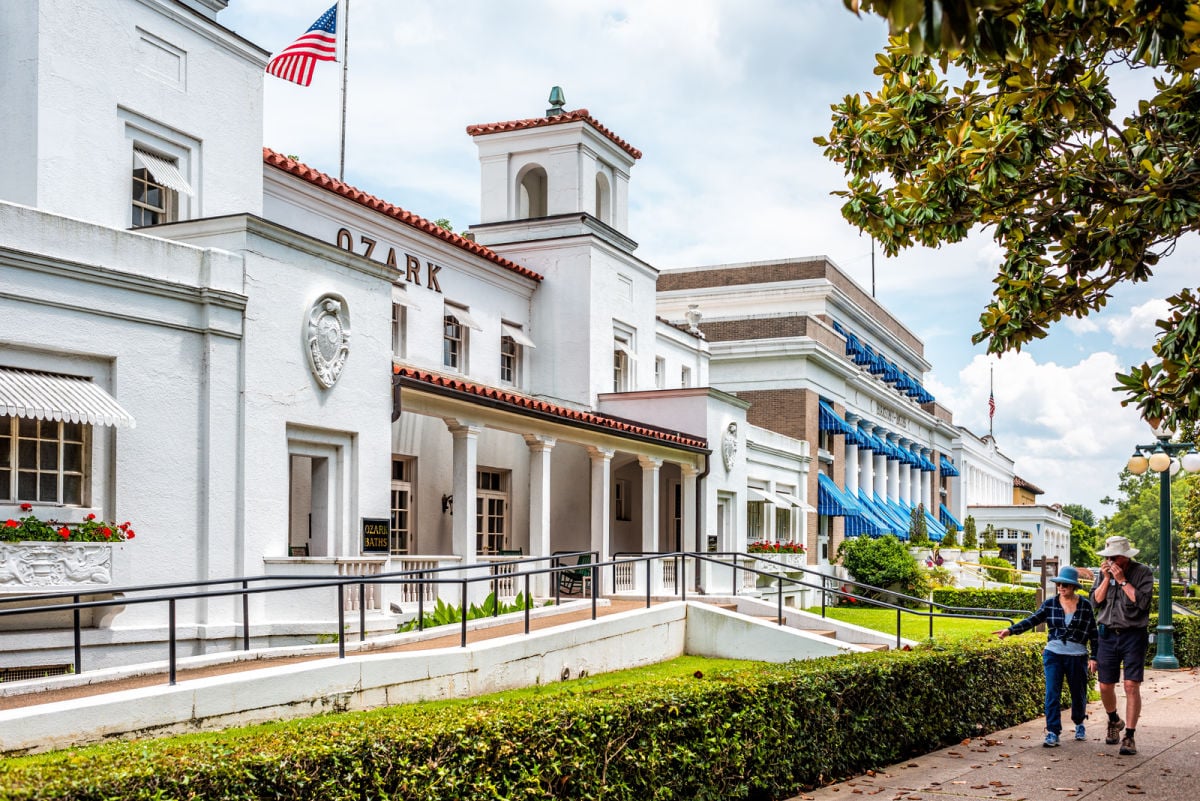 Couple walking past historic Hot Springs bath house